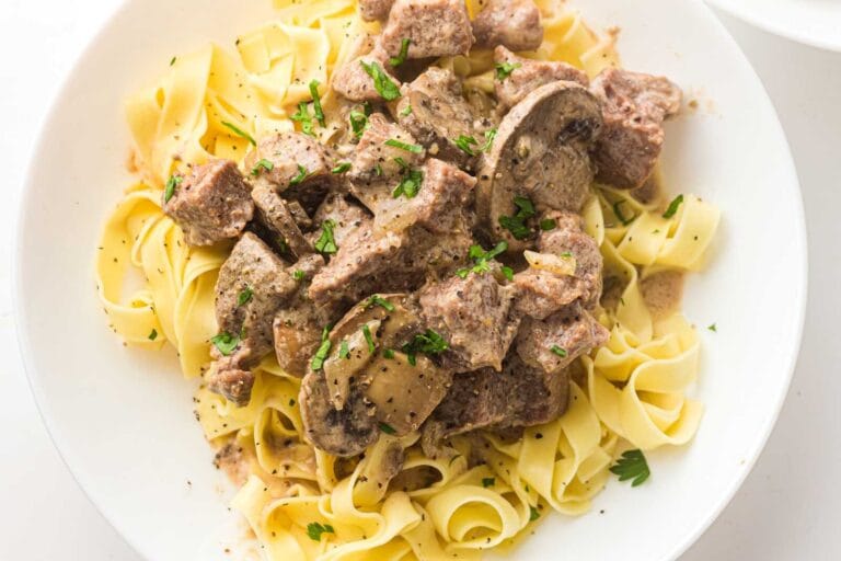 Slow cooker beef stroganoff with mushrooms served over egg noodles.